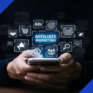 A person holds a smartphone with a digital display of "Affiliate Marketing" and icons for ads, sales, and analytics, symbolizing the services from JR Digital Media.
