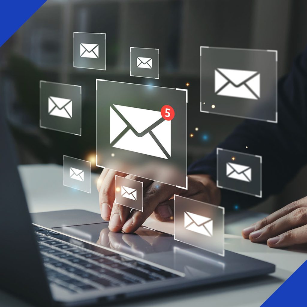 A person's hands on a laptop with a futuristic interface displaying multiple email icons, symbolizing the strategic email marketing services from JR Digital Media.