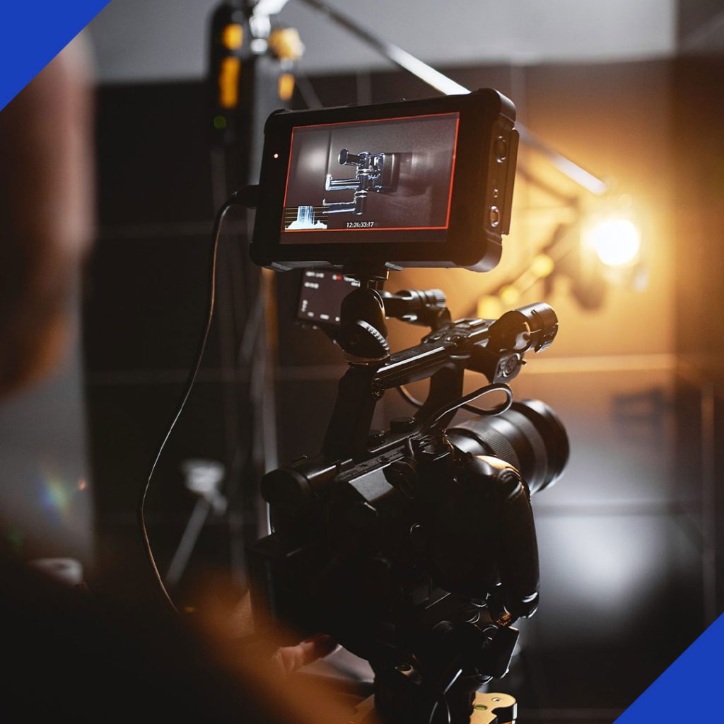 A professional video camera on a media production set with a monitor attached, symbolizing the expert media production services from JR Digital Media.